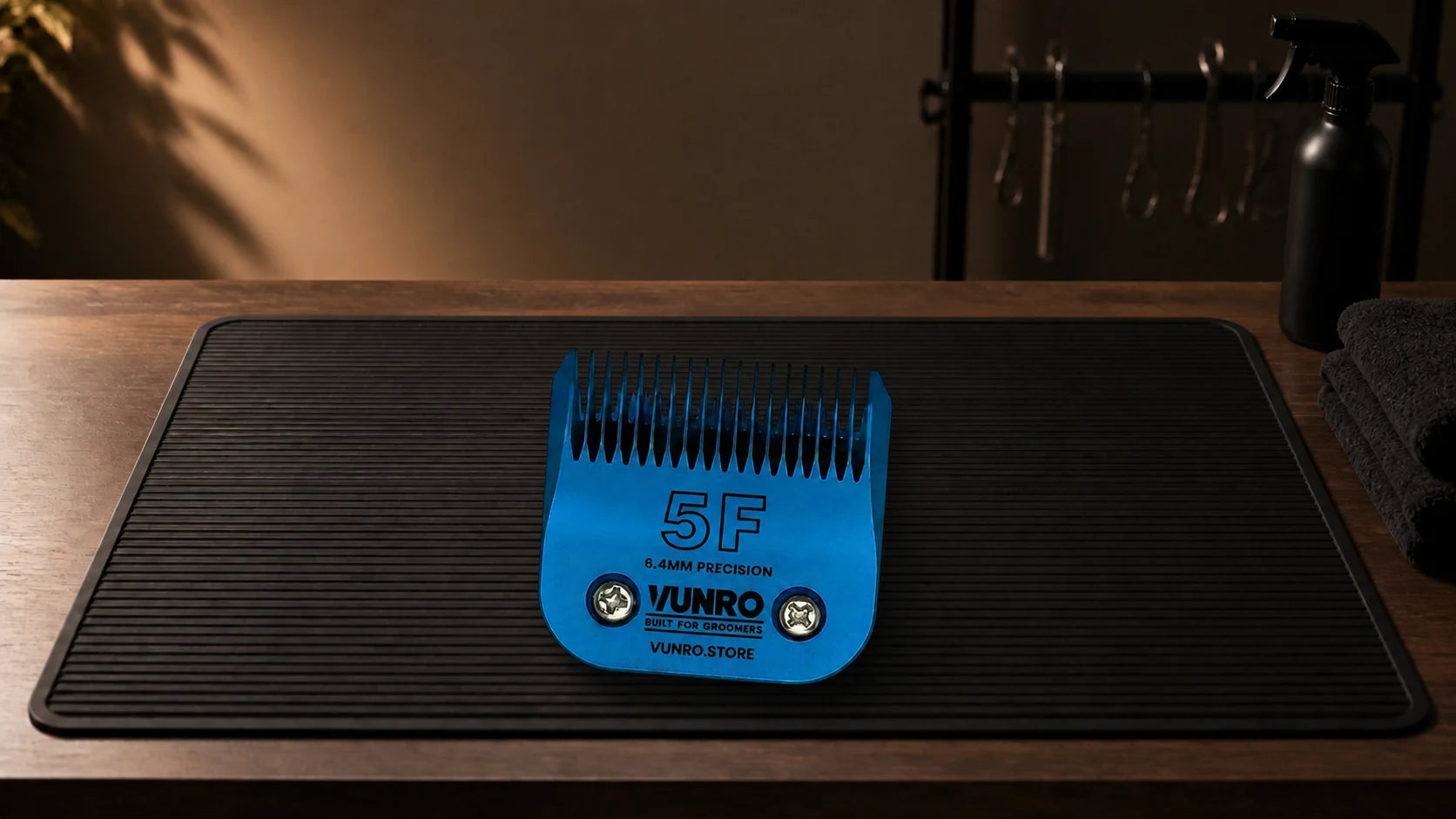 #5F Blue Steel Dog Clipper Blade (6.4 mm) resting naturally on the VUNRO grooming workbench